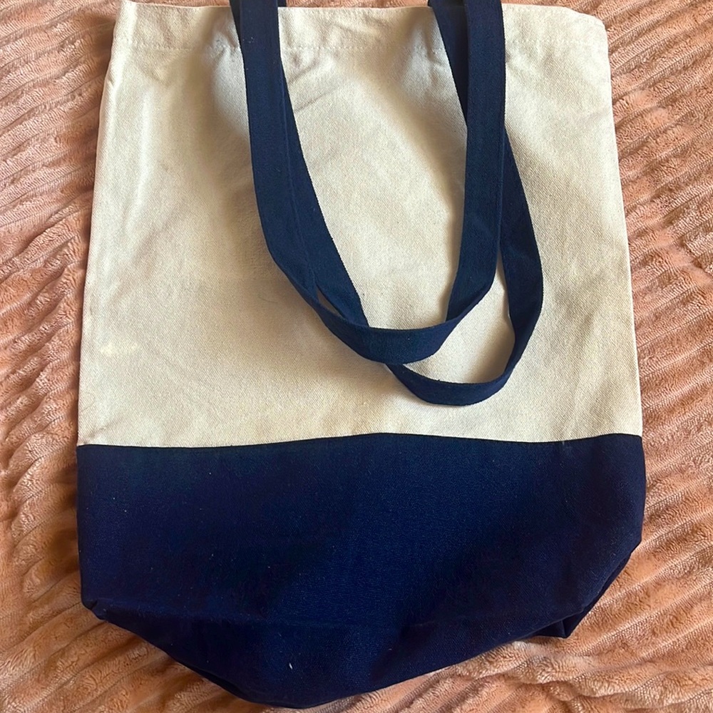 This is a tan and navy blue tote bag